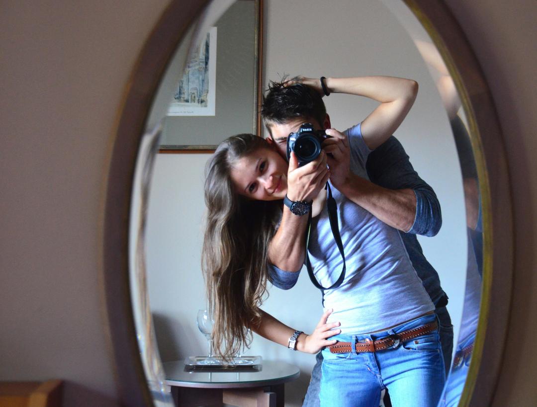 couple taking a photo in a mirror